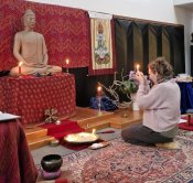 Suvarnadhi making an offering during puja (ABC)