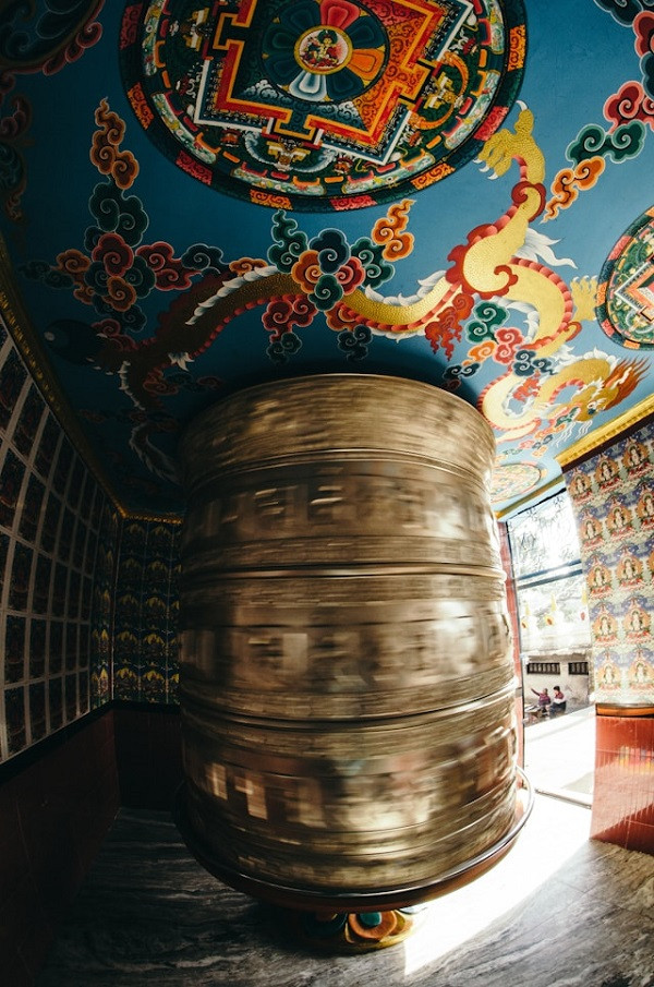 Large spinning prayer wheel with a mandala above it