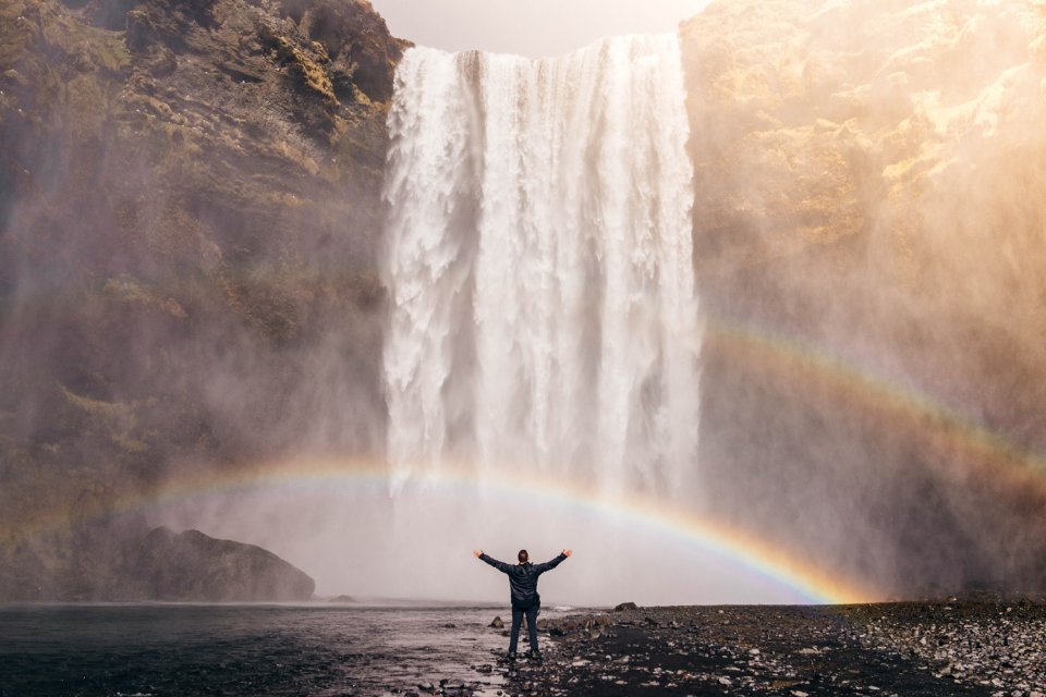Rainbow below an enormous waterfall