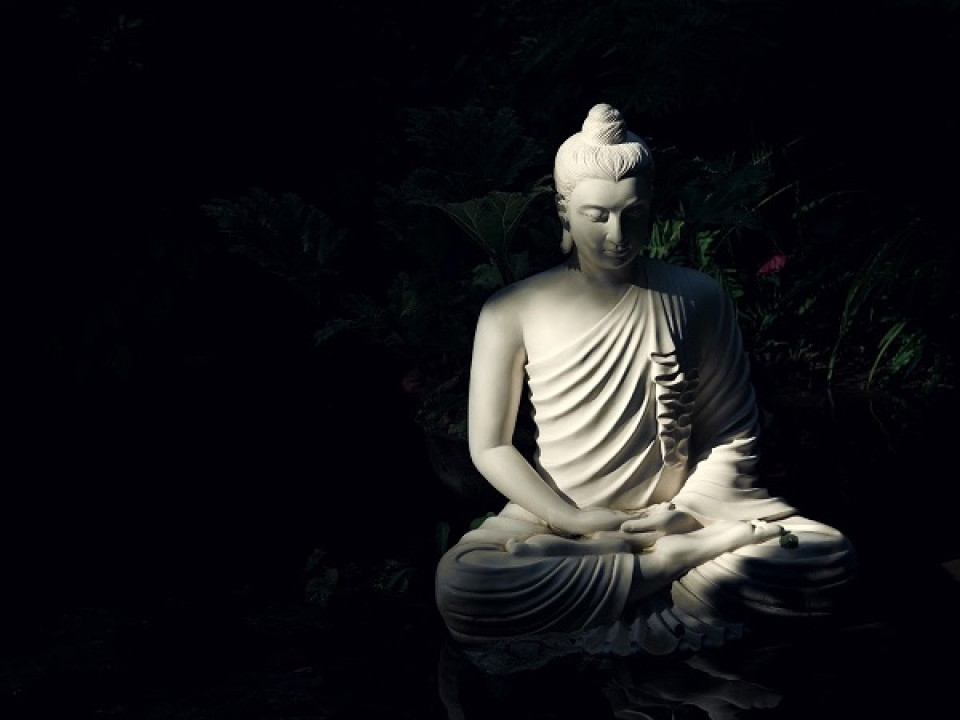 White Buddha on a black background