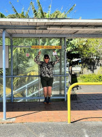 Rohan pointing at the Coast to Coast walkway sign (ABC)