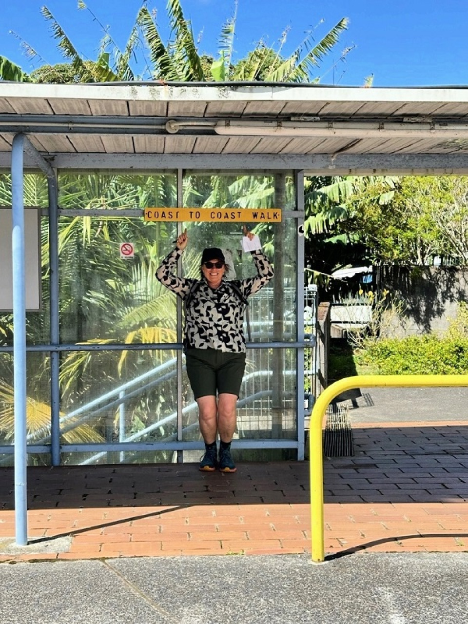 Rohan pointing at the Coast to Coast walkway sign (ABC)