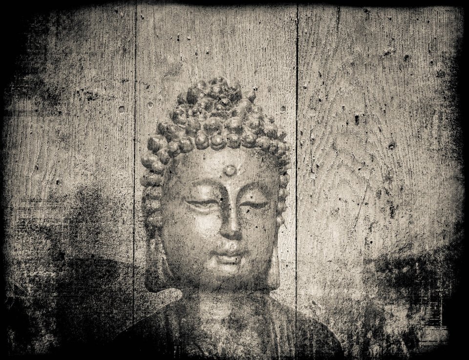 Etching of a Buddha on old wooden panels