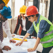 Construction workers looking at building plans