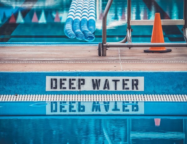 Deep water warning sign by a pool