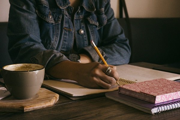 Person writing in a notebook