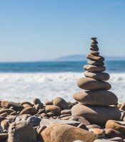 Stupa of stones perfectly balanced by the water