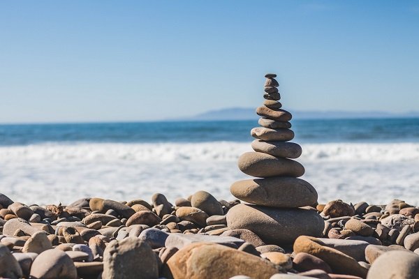 Stupa of stones perfectly balanced by the water