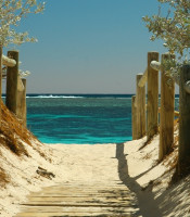 Sandy walkway to a beautiful blue beach