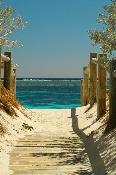 Sandy walkway to a beautiful blue beach