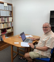 Buddhanusarin sitting at work on his laptop in the library